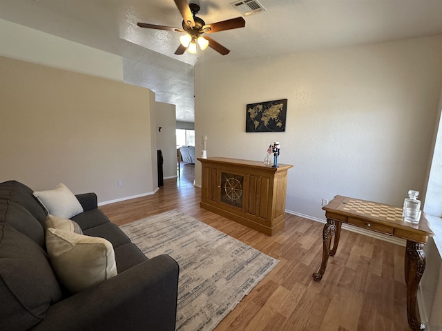 11228 E 25th St, Yuma, AZ 85367 - living room with baseboards, light wood-type flooring, and a ceiling fan
