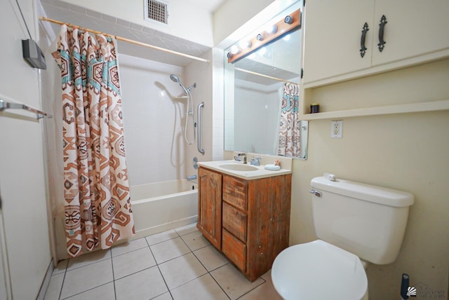 full bathroom with visible vents, vanity, toilet, tile patterned floors, and shower / tub combo