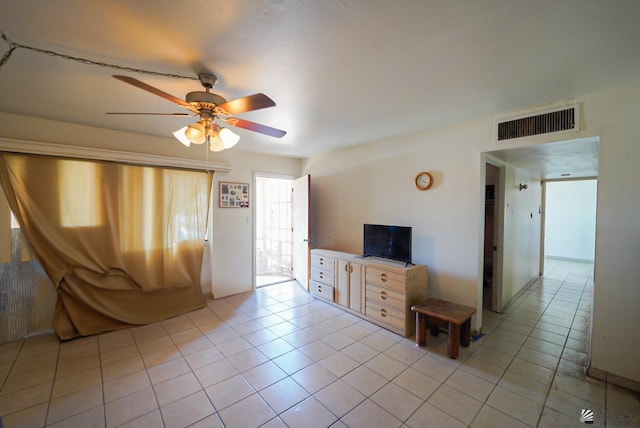 unfurnished living room featuring visible vents, a ceiling fan, and light tile patterned floors