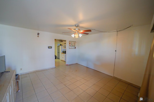 unfurnished room with light tile patterned floors and a ceiling fan