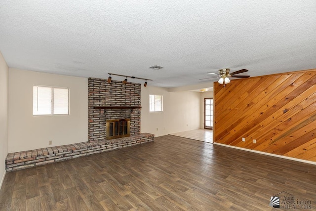 2413 W 13th Pl, Yuma, AZ 85364 - unfurnished living room featuring rail lighting, ceiling fan, wood finished floors, plenty of natural light, and a textured ceiling