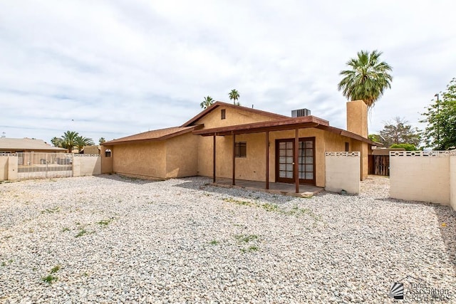 2413 W 13th Pl, Yuma, AZ 85364 - rear view of property featuring french doors, fence, a patio, and stucco siding