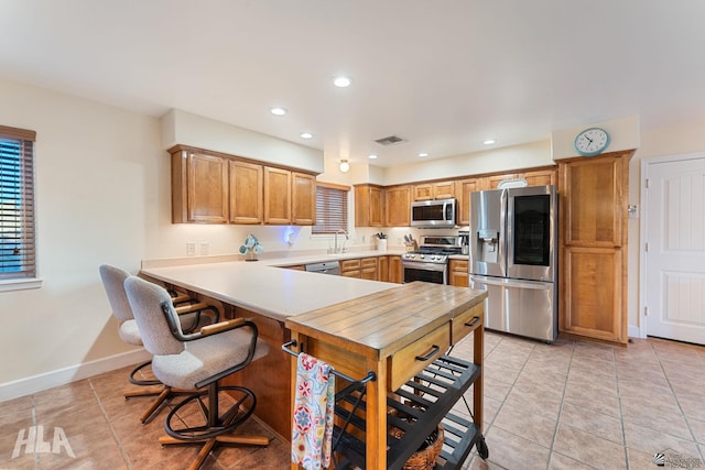 14445 E 53rd Dr, Yuma, AZ 85367 - kitchen with visible vents, appliances with stainless steel finishes, a sink, light tile patterned floors, and baseboards