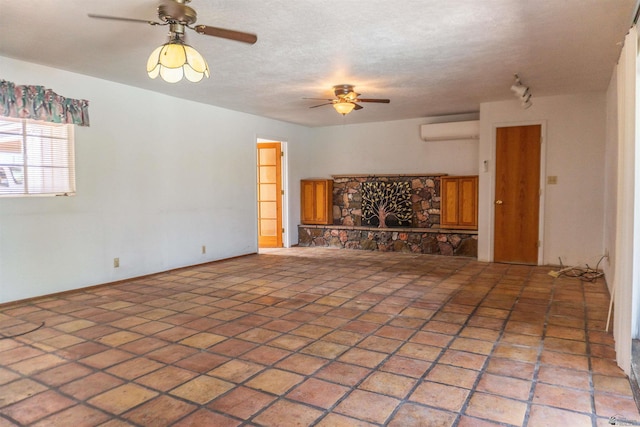unfurnished living room with a ceiling fan and a wall unit AC