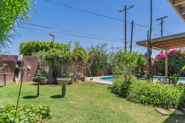 view of yard featuring a fenced in pool and a fenced backyard