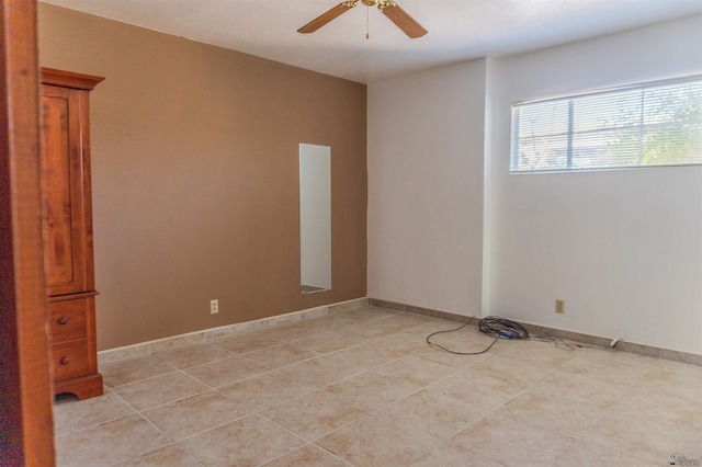 empty room featuring light tile patterned floors and ceiling fan