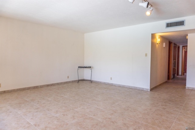 spare room with visible vents and light tile patterned floors