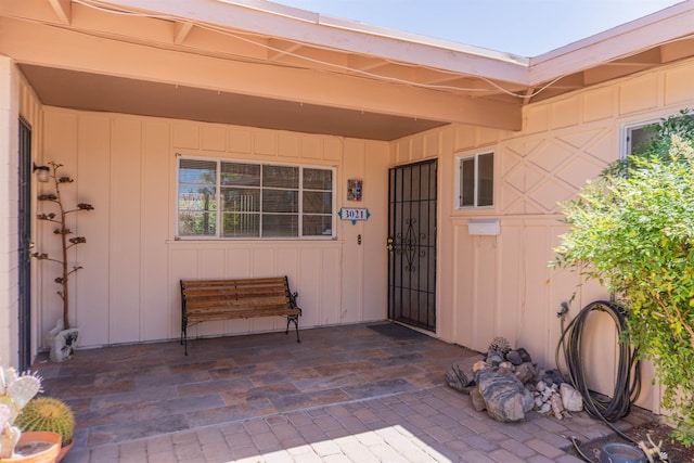 view of exterior entry featuring board and batten siding