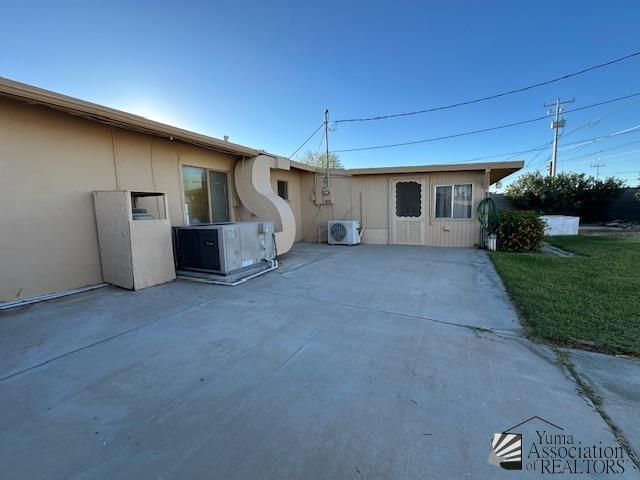 exterior space featuring ac unit and a patio area