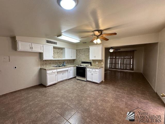 kitchen featuring white cabinets, ceiling fan, a sink, white gas range, and visible vents