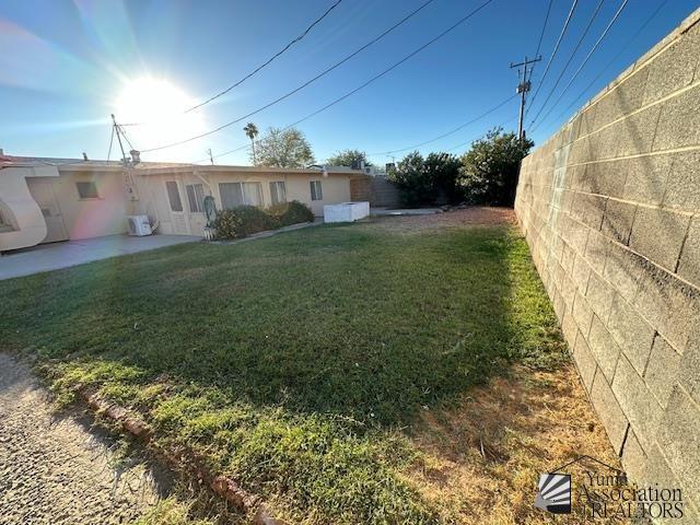 exterior space with a patio, a front lawn, and fence