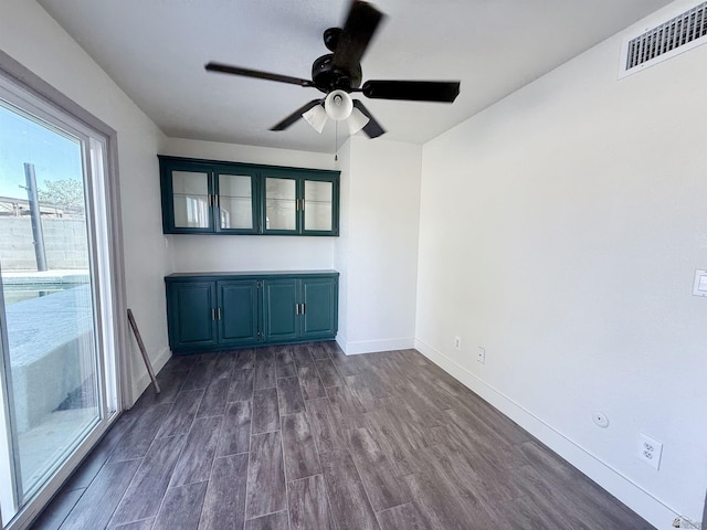 2472 S 18th Ave, Yuma, AZ 85364 - unfurnished room with baseboards, dark wood-style flooring, and a ceiling fan