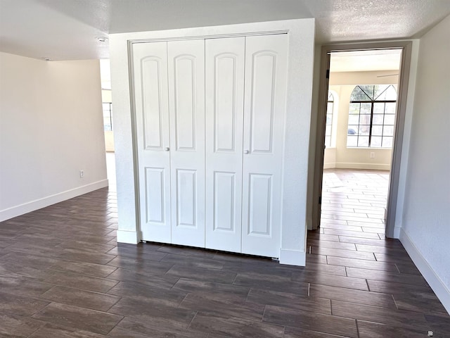2472 S 18th Ave, Yuma, AZ 85364 - unfurnished bedroom with a closet, dark wood finished floors, and baseboards