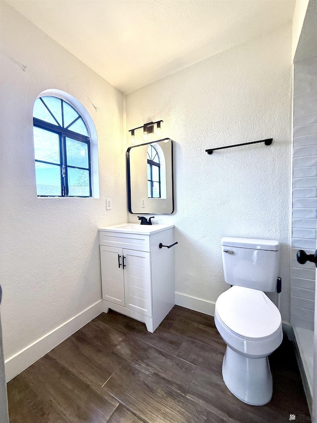 2472 S 18th Ave, Yuma, AZ 85364 - bathroom with vanity, wood finished floors, toilet, baseboards, and a textured wall