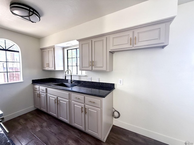 2472 S 18th Ave, Yuma, AZ 85364 - kitchen featuring a sink, dark countertops, baseboards, and dark wood-style flooring