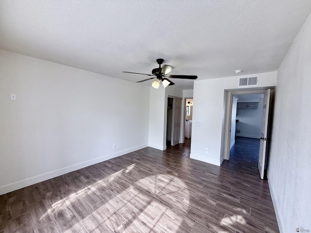 2472 S 18th Ave, Yuma, AZ 85364 - empty room with a textured ceiling, ceiling fan, baseboards, and dark wood-style floors