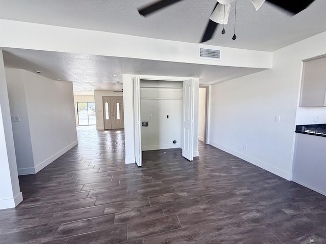 2472 S 18th Ave, Yuma, AZ 85364 - unfurnished living room with baseboards, a textured ceiling, a ceiling fan, and dark wood-style flooring