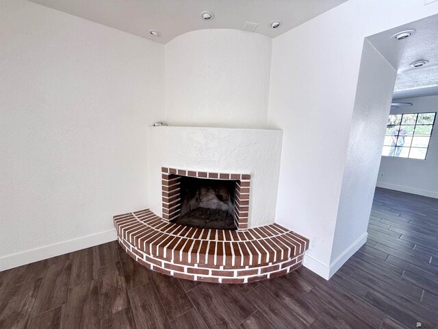 2472 S 18th Ave, Yuma, AZ 85364 - detailed view of baseboards, wood finished floors, and a fireplace
