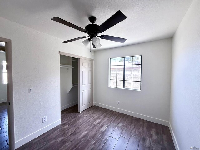 2472 S 18th Ave, Yuma, AZ 85364 - unfurnished bedroom featuring dark wood-type flooring, a closet, baseboards, a textured wall, and ceiling fan