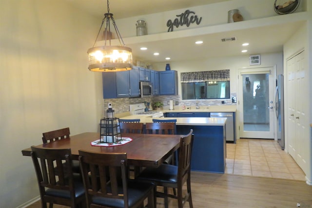 dining area featuring light wood-type flooring