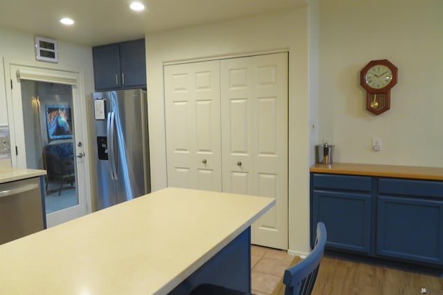 kitchen featuring blue cabinets and stainless steel appliances