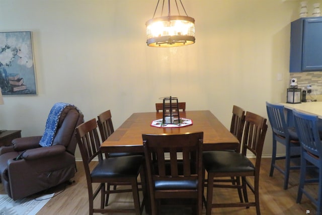 dining space with light hardwood / wood-style flooring