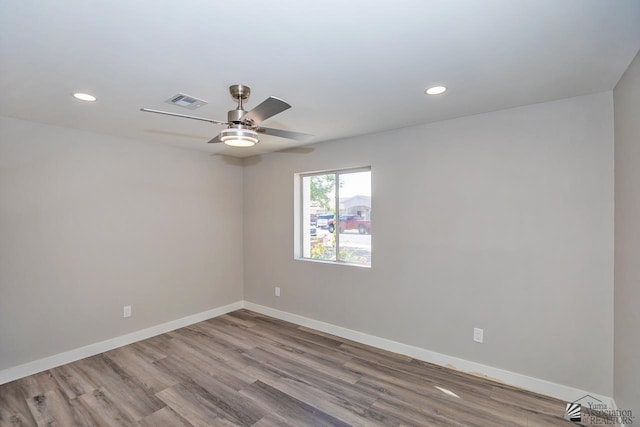 spare room with light hardwood / wood-style flooring and ceiling fan