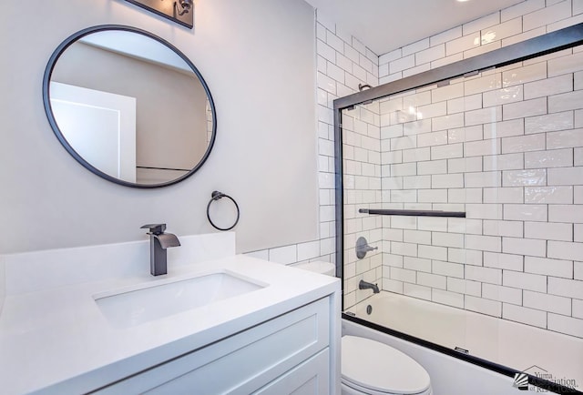 full bathroom with toilet, vanity, and shower / bath combination with glass door