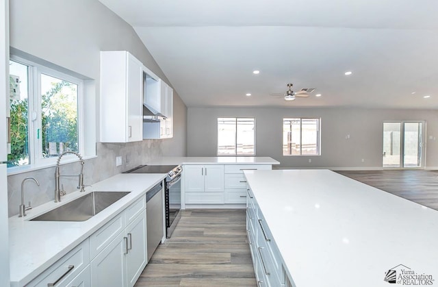 kitchen featuring backsplash, stainless steel appliances, sink, and white cabinets