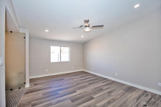 spare room featuring ceiling fan and hardwood / wood-style floors