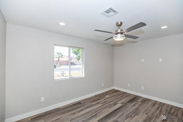 unfurnished room featuring dark wood-type flooring and ceiling fan