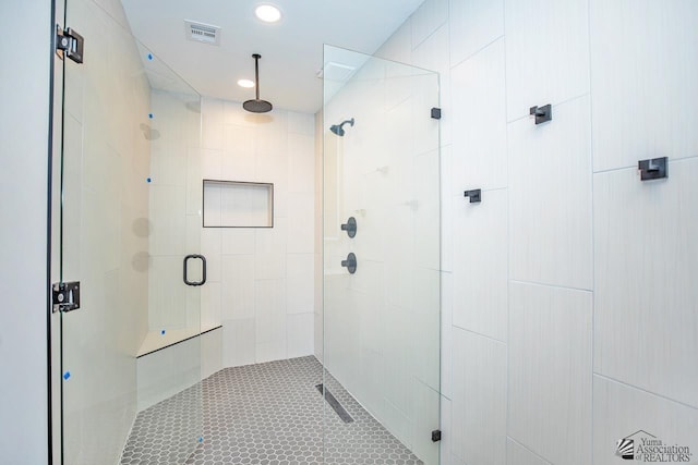 bathroom featuring tile patterned flooring and an enclosed shower