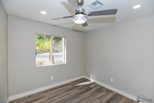 empty room with ceiling fan and dark hardwood / wood-style flooring