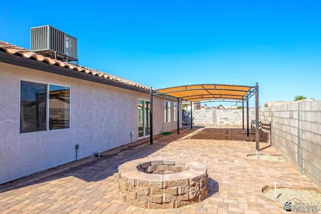 view of patio featuring an outdoor fire pit, a pergola, and central air condition unit