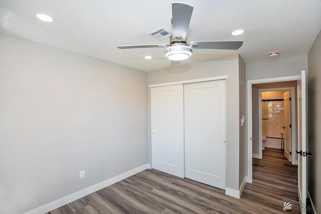 unfurnished bedroom featuring ceiling fan, dark hardwood / wood-style flooring, and a closet