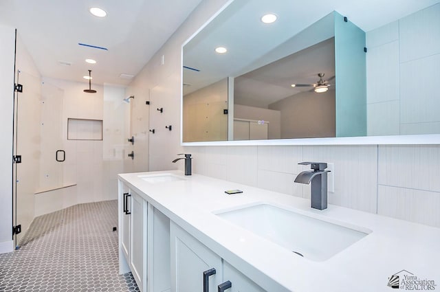 bathroom with a shower with door, ceiling fan, tile walls, backsplash, and tile patterned floors