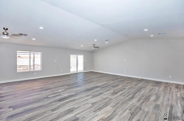 empty room with lofted ceiling, light wood-type flooring, and ceiling fan