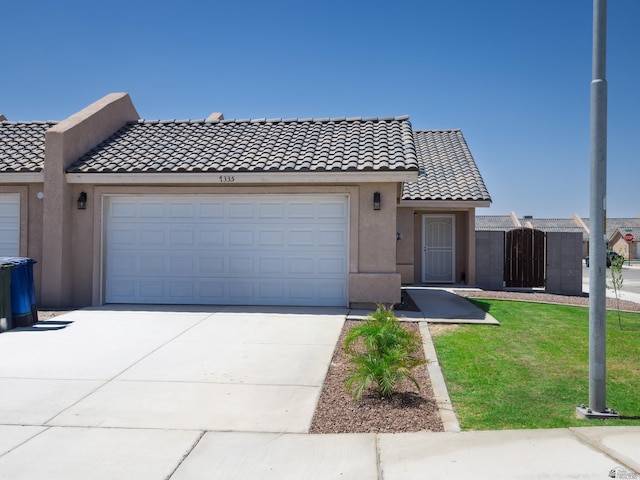 7335 E 36th Rd, Yuma, AZ 85365 - view of front facade with a tiled roof, a garage, stucco siding, and concrete driveway