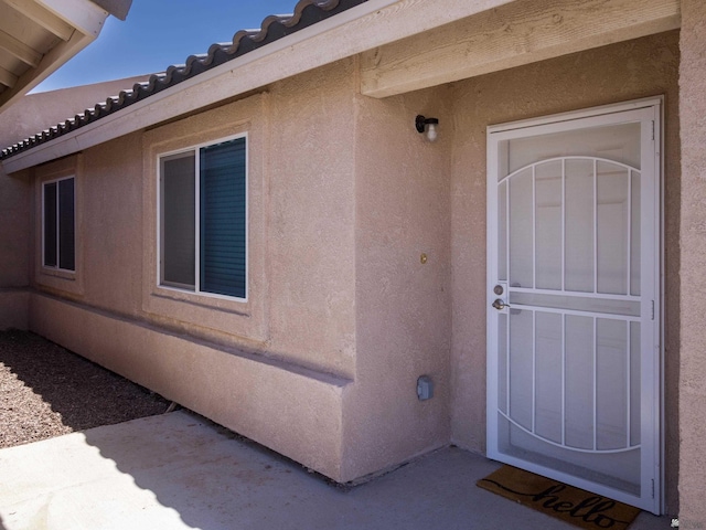 7335 E 36th Rd, Yuma, AZ 85365 - view of exterior entry with stucco siding and a tiled roof