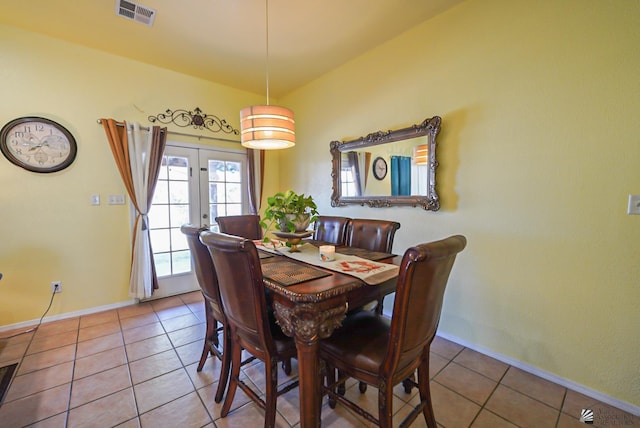 tiled dining room featuring baseboards, visible vents, and french doors
