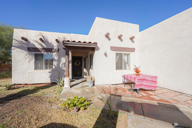 adobe home featuring stucco siding
