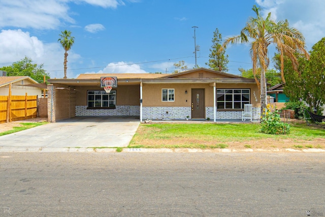 2556 W 14th St, Yuma, AZ 85364 - view of front facade featuring stucco siding, concrete driveway, and an attached carport