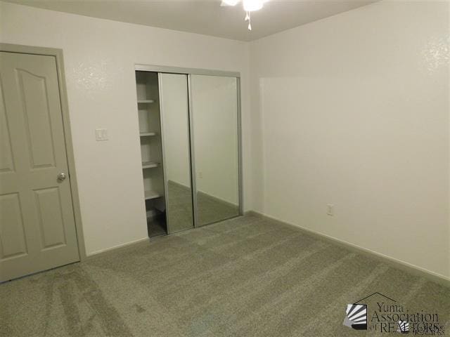 11785 E 27th Pl, Yuma, AZ 85367 - unfurnished bedroom featuring carpet flooring, a closet, and baseboards