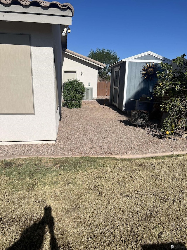 11785 E 27th Pl, Yuma, AZ 85367 - view of grassy yard with a shed, an outdoor structure, and central AC unit