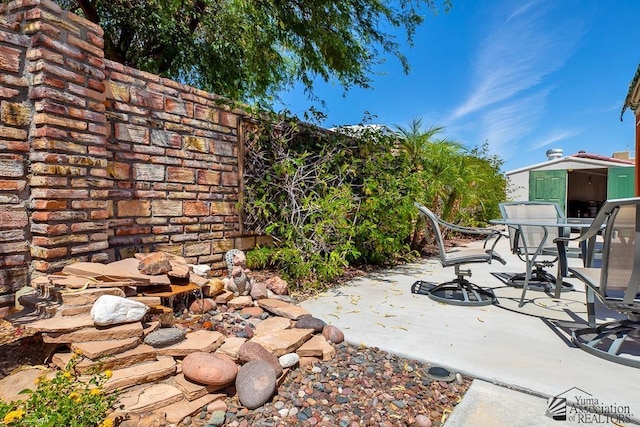 13400 S Onammi Ave, Yuma, AZ 85367 - view of patio featuring outdoor dining space and an outdoor structure