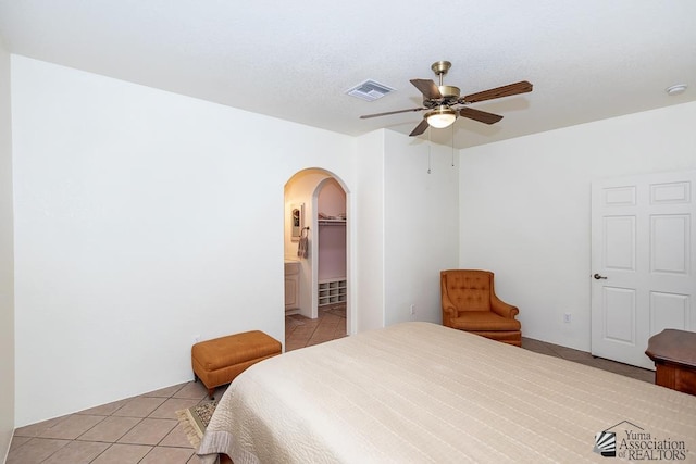 13400 S Onammi Ave, Yuma, AZ 85367 - bedroom with light tile patterned flooring, arched walkways, and ceiling fan