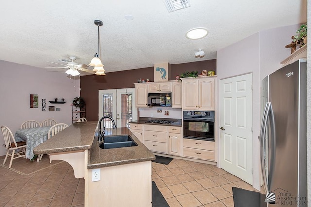 13400 S Onammi Ave, Yuma, AZ 85367 - kitchen featuring black appliances, light tile patterned floors, ceiling fan, an island with sink, and dark countertops