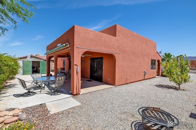 13400 S Onammi Ave, Yuma, AZ 85367 - rear view of house with a patio, stucco siding, ceiling fan, and an outdoor structure