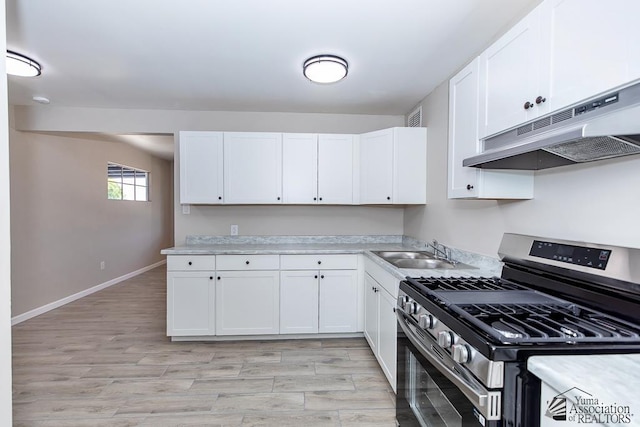 2735 S Mesa Ave, Yuma, AZ 85364 - kitchen with stainless steel gas stove, under cabinet range hood, a sink, and light countertops