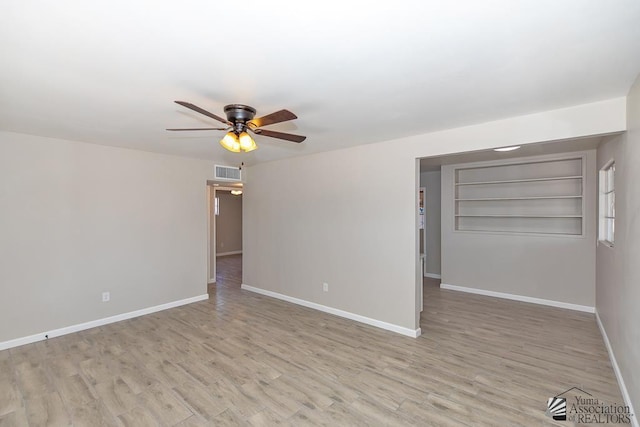2735 S Mesa Ave, Yuma, AZ 85364 - empty room with ceiling fan, baseboards, and wood finished floors